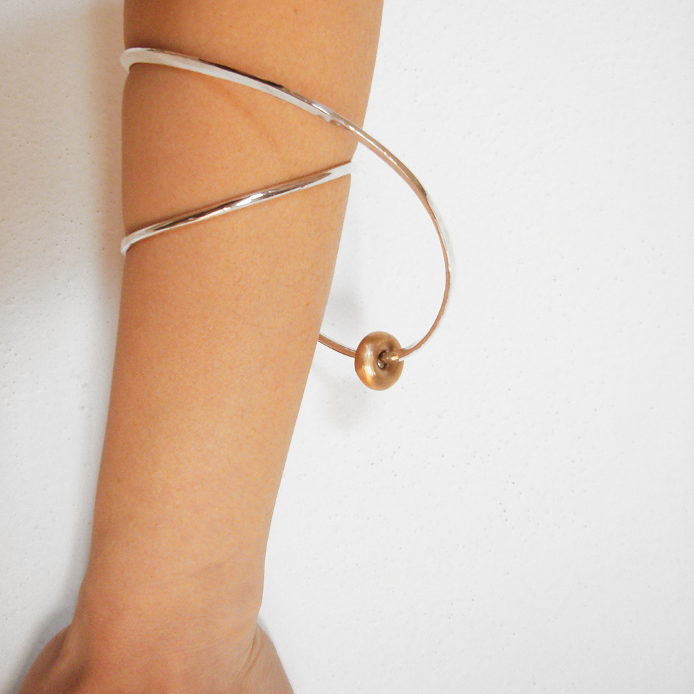 Silver bangle with bronze bead