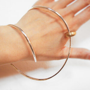Silver bangle with bronze bead