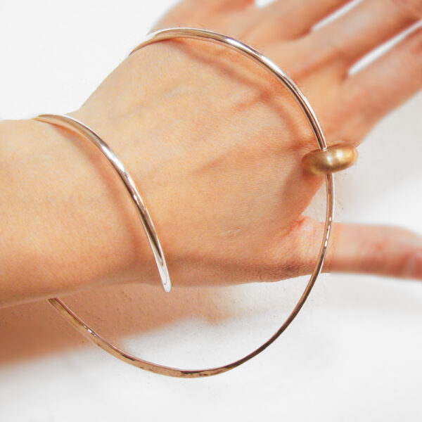 Silver bangle with bronze bead